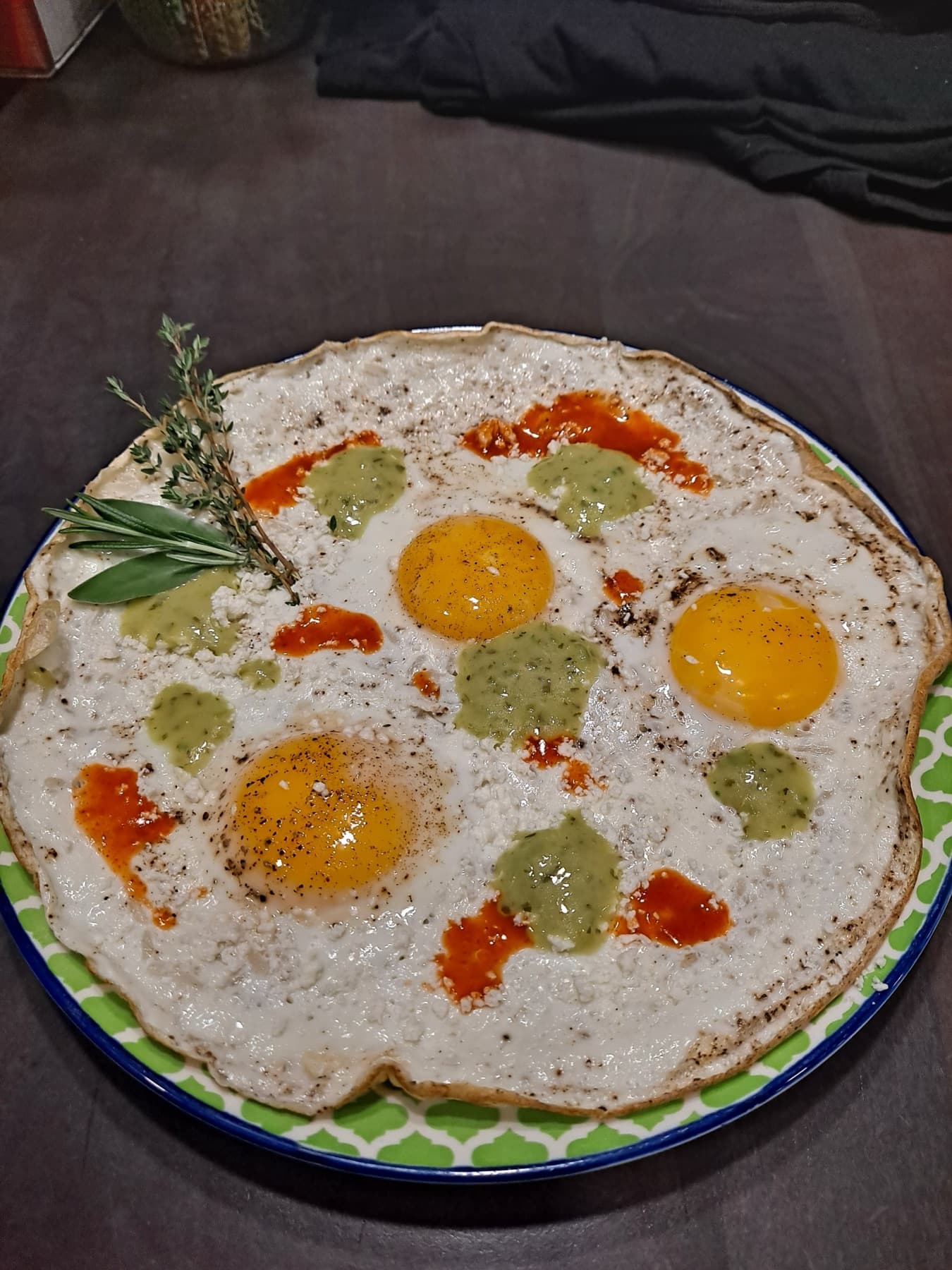 Fried eggs with chimichurri and hot sauce